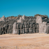 a large stone wall in the middle of a desert