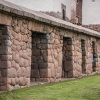 a row of stone walls next to a building