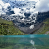 a mountain range with a lake in the foreground