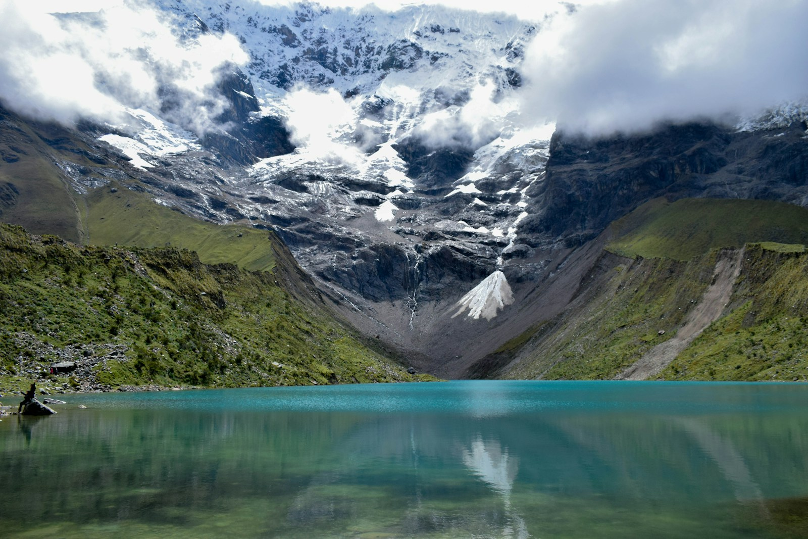 a mountain range with a lake in the foreground